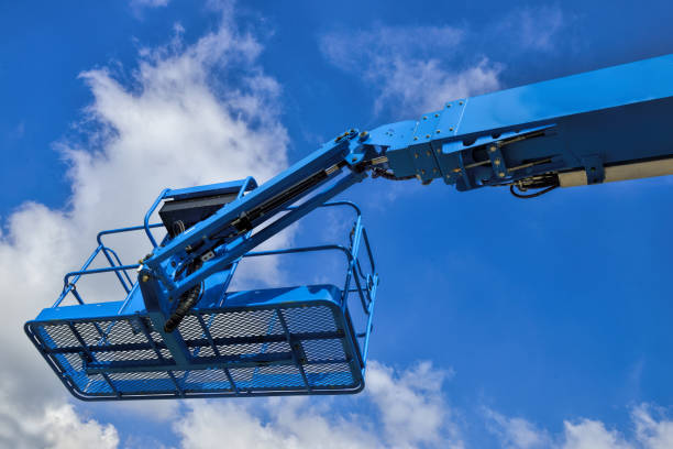 istock Industrial boom lift basket against a blue sky. 1427245882