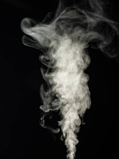 istock Fluffy white smoke swirls and rises upwards as an abstract effect 1427246484