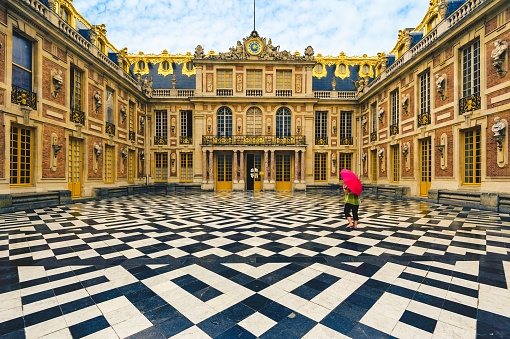 June 18, 2015: Marble Court and facades of the first Chateau in Palace of Versailles, Paris, France. It was embellished by Louis Le Vau in 1661 to 1668, and then Hardouin Mansart in 1679 to 1681.