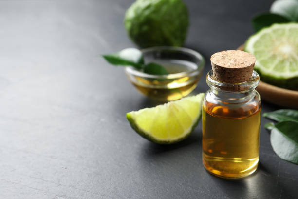 istock Bottle of bergamot essential oil on dark table. Space for text 1427246630