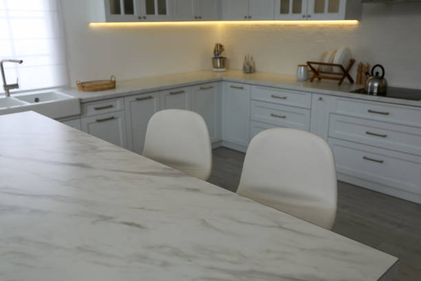 istock Modern kitchen interior with white marble table and stylish chairs 1427247742