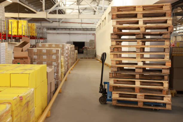 istock Modern manual forklift with wooden pallets in warehouse 1427248092