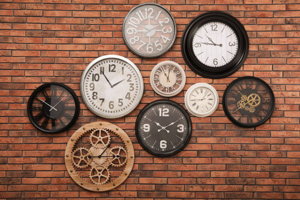 istock Collection of clocks hanging on red brick wall 1427248440