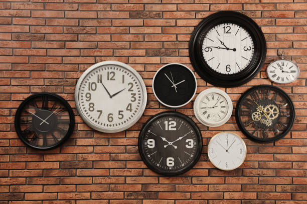 istock Collection of clocks hanging on red brick wall 1427248442