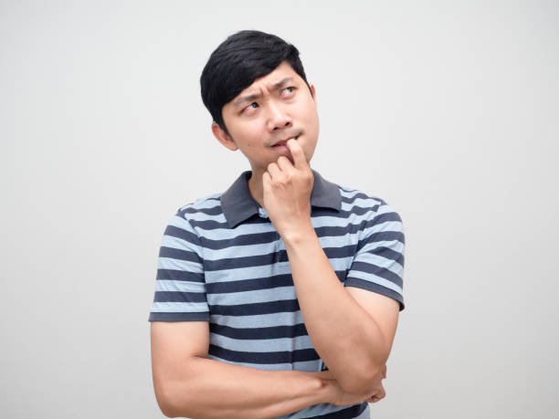 istock Young man striped shirt gritted teeth serious thinking portrait 1427250212