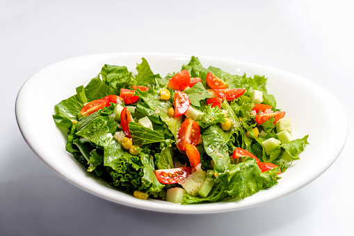 Warm salad with vegetables, arugula and veal
