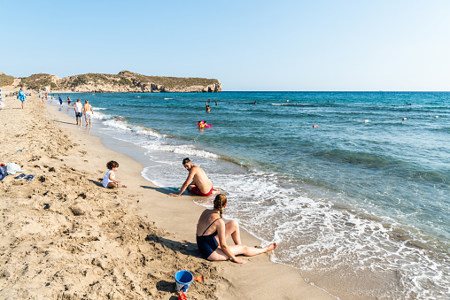 Patara, Antalya, Turkey  August 12, 2021. Patara beach in Antalya province of Turkey, with people. The splendid 18-km long sandy beach is backed by large sand dunes.