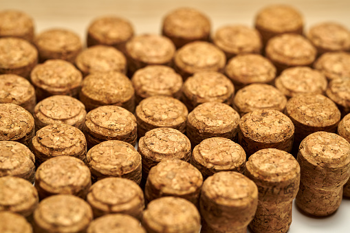 Closeup of a wall of used wine corks. A random selection of used wine corks, some with vintage years.