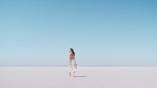 istock Young female tourist walking on white salt in Salt Lake Türkiye 1427255299