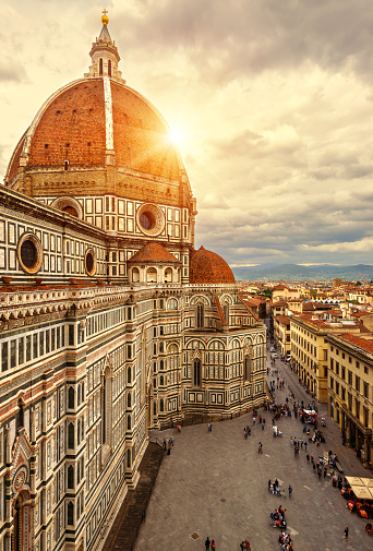 Florence in summer, Italy, Europe. Vertical sunny view of Duomo or Basilica di Santa Maria del Fiore (St Mary of Flower), top landmark of Florence city. Scenery of Florence cathedral in sunset light