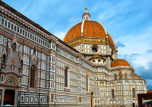 Duomo or Basilica di Santa Maria del Fiore, Florence, Italy. It is top landmark of Florence city. Old Cathedral of St Mary of Flower with red dome under blue sky. Travel, tourism and culture concept