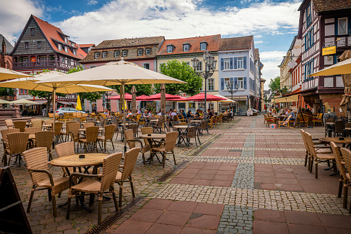 Neustadt an der Weinstrasse, Germany - July 31, 2022: Town square in Neustadt an der Weinstrasse in Rhineland-Palatinate in Germany. Some restaurants are at this place.