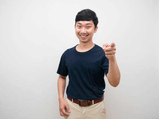 istock Man smiling point finger at you standing studio shot 1427259546