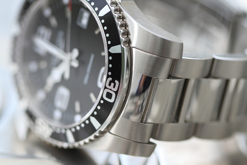 a noble diving watch with metal bracelet and black dial