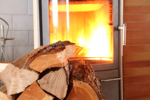 a woodburning stove with wood and pellets stock photo