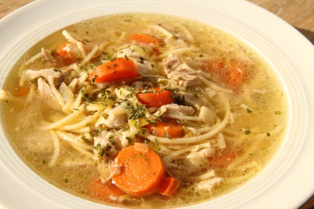 a delicious chicken soup with carrots stock photo