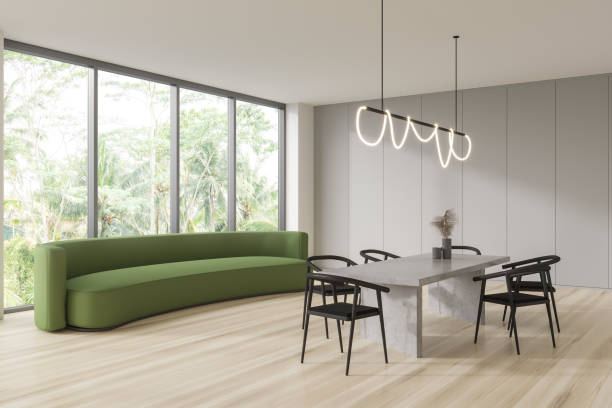 istock Light studio room interior with couch and chairs, relax and eating space 1427266422
