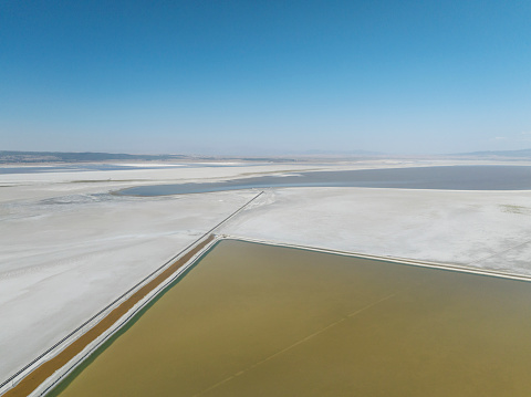 Aerial view of colorful salt ponds and suplhur ponds. Taken via drone. Acigol Lake (Acı Göl) in Denizli, Turkey.