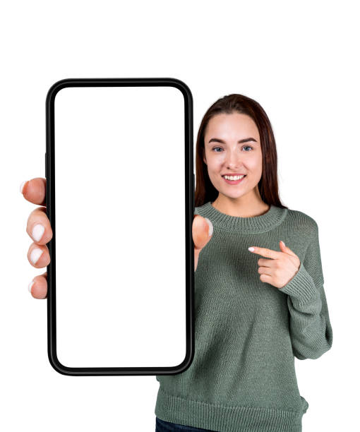 istock Young woman pointing at large phone blank display, isolated over 1427266741