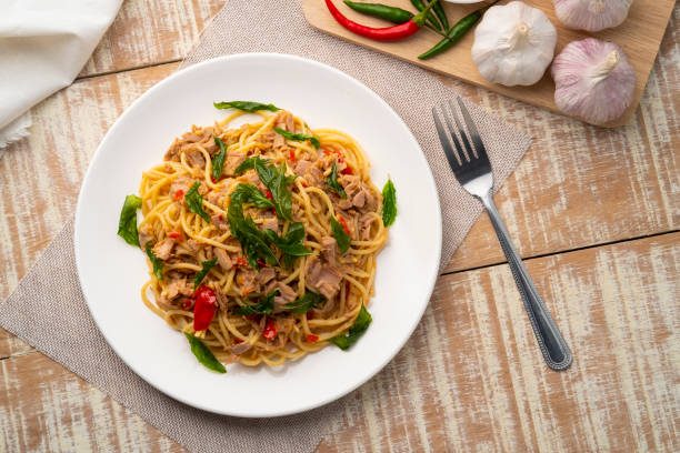 istock Stir fried Spaghetti with Canned tuna fish and crispy basil leaves 1427268001