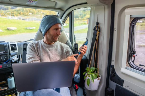 istock Young man studying in a van, on the move learning concept 1427268586