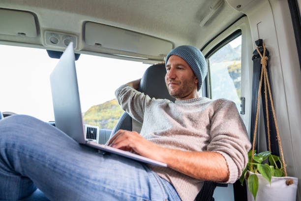 istock Young man studying in a van, on the move learning concept 1427268710