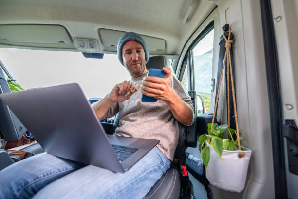 istock Young man studying in a van, on the move learning concept 1427268712