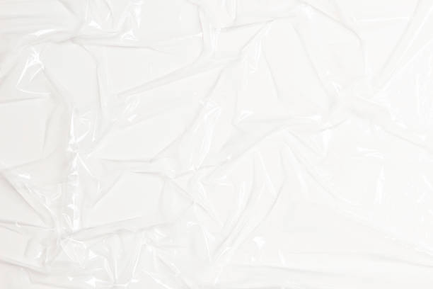 istock Wrinkled plastic wrap on white color background. Crumpled transparent plastic cellophane. Reflecting light and shadow on creases and folds in plastic surface. Texture overlay effect template 1427269802