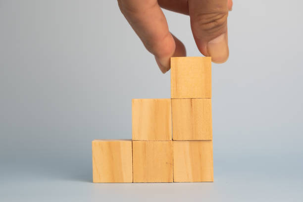 istock hand holding cube wood block blank on background. copy space 1427270289
