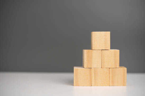istock hand holding cube wood block blank on background. copy space 1427270312