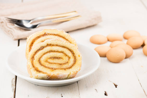 Swiss roll cake made from biscuit and egg dough. Sweet tasty Roulade pie. Traditional wedding and celebration cake. Homemade bakery. Apricot jam.