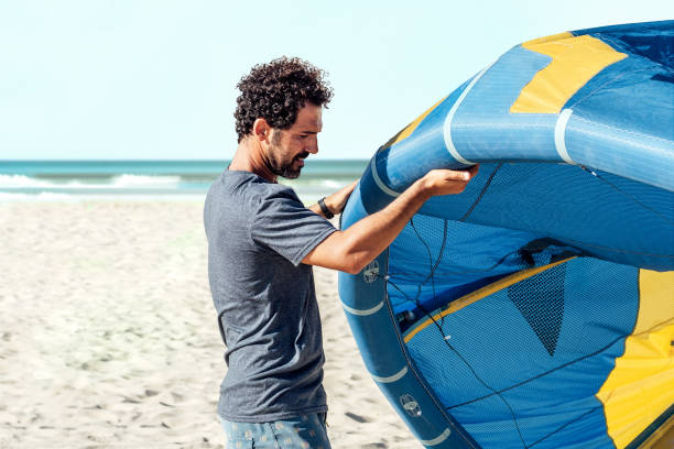 istock Man preparing kiteboarding kite before kitesurfing. Preparation before kiting. 1427273488
