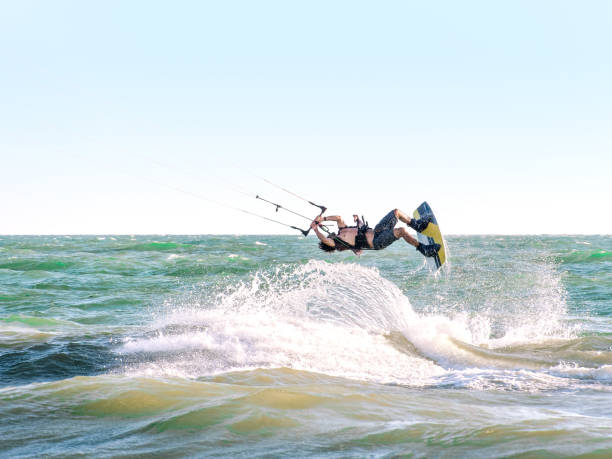 istock Young man kite boarder jumps over the sea at sunset. Selective focus. 1427273516