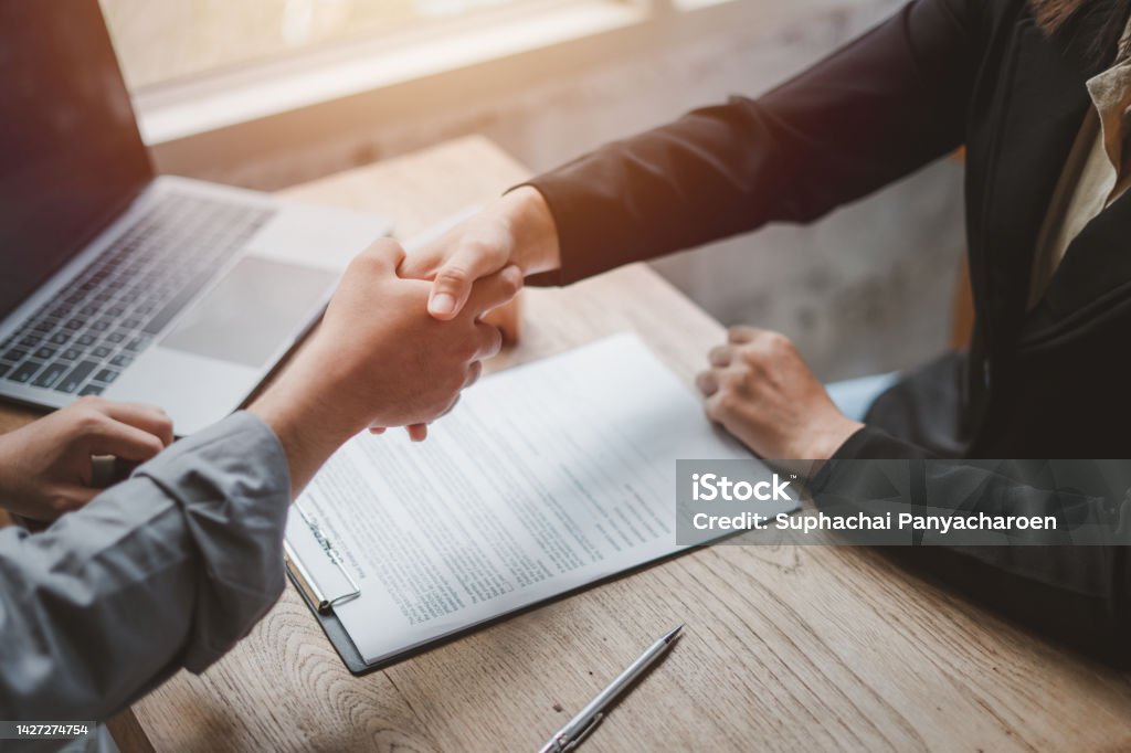 Business negotiations real estate agents women shaking hands with clients after signing property sales contracts giving advice, passing bank approvals and installments, Concept new house moving house. Agreement Stock Photo