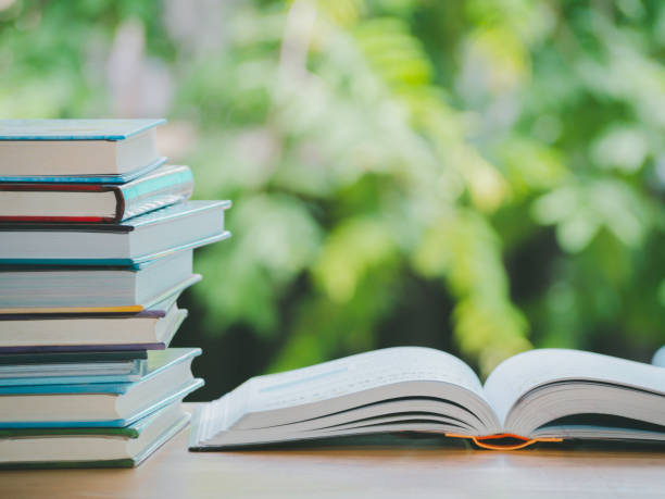 istock Open hardcover book for education on the table in garden. 1427275987