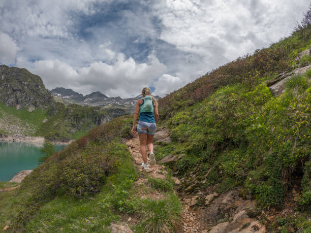 istock Woman trail runner contemplates mountain landscape 1427277486