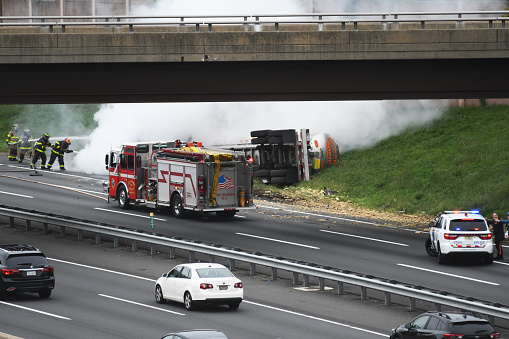 Port Reading, NJ/US- September 25, 2022: A fuel truck traveling on the New Jersey turnpike southbound flips over and catches fire on the shoulder of the highway.