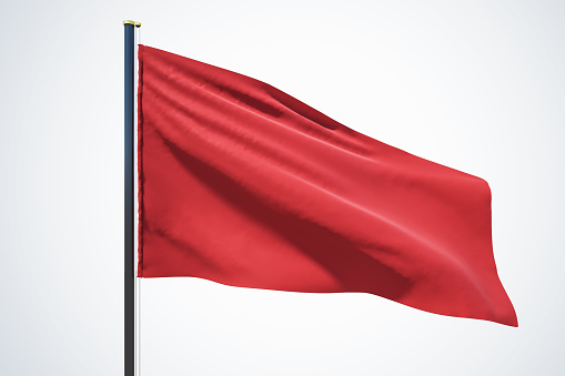 Blank red flag waving in the wind with copyspace for your logo or text isolated on light grey background. 3D rendering, mock up