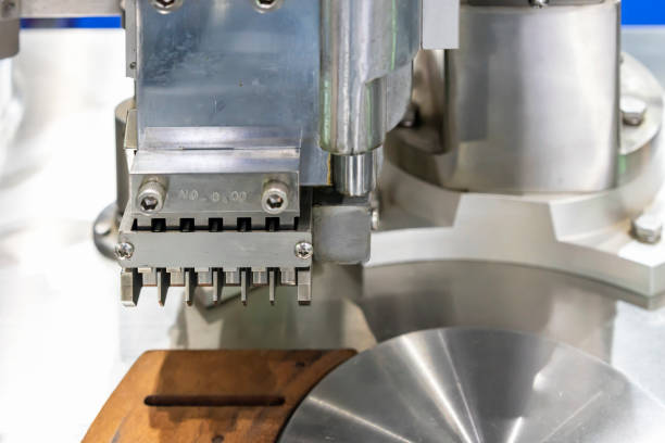 istock close up metal stainless steel capsule sorting plate and vertical feeding fork component of automatic capsule filling machine for industrial 1427280549