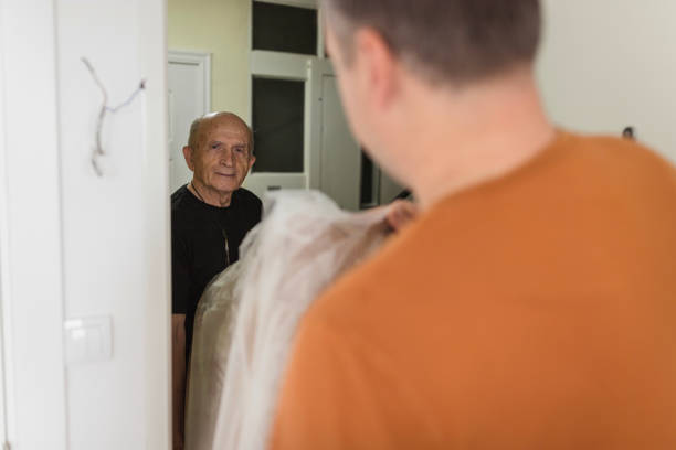 istock Senior carpenter having help when moving his furniture 1427280552