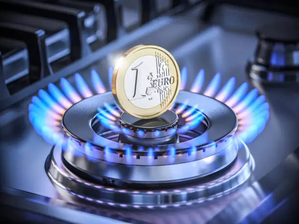 Photo of One euro coin on the range burner of a natural gas home stove surrounded by a blue flame. 3D render