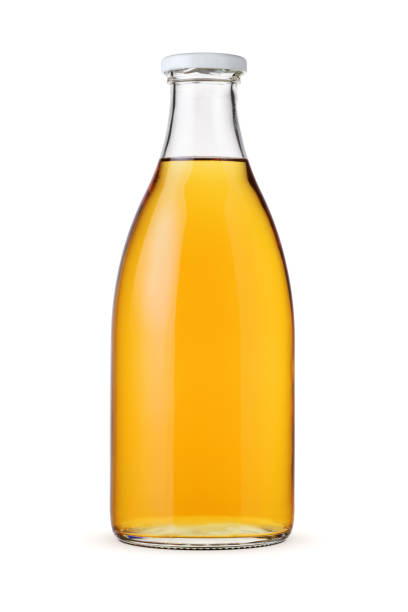 istock Apple juice in a glass bottle isolated. 1427288787