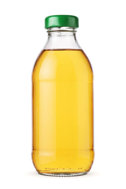 istock Apple juice in a glass bottle isolated. 1427288794