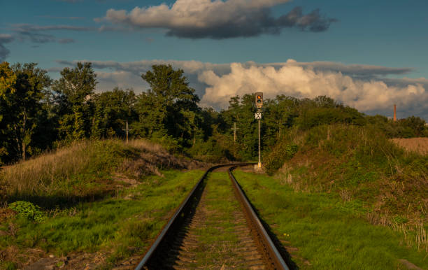 Old non electrified railway track near Rakovnik town in sunset evening stock photo