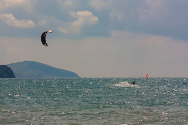 istock riding the kite in the sea on the waves 1427308749