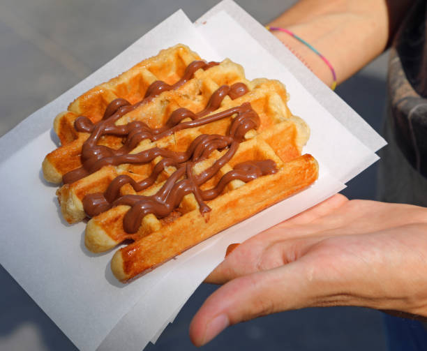 waffle the typical belgian dessert with hazelnut cream garnish - brussels waffle belgian waffle people imagens e fotografias de stock