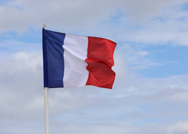 istock French Flag wavings on the blue sky without people 1427309149