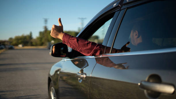 istock Man showing thumbs up from car window 1427316565