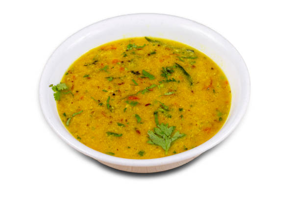 Indian popular food Dal fry or traditional Dal Tadka Curry, isolated over white background, selective focus. Indian popular food Dal fry or traditional Dal Tadka Curry, isolated over white background, selective focus. giant snakehead stock pictures, royalty-free photos & images