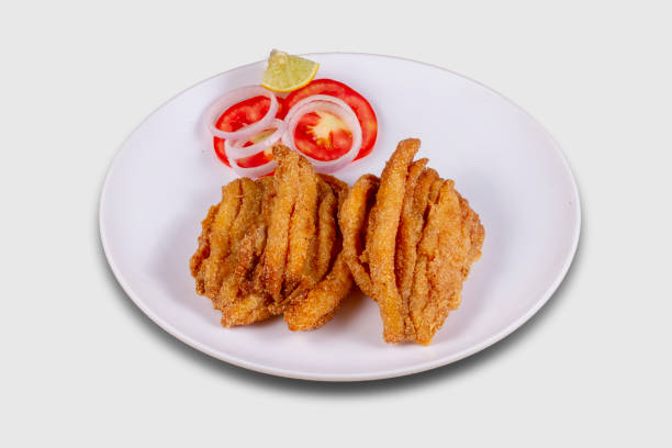 Bombay duck fry Served in a plate over white background. Selective focus.